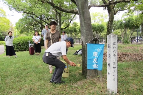 「東京の木」にひしゃくで水を掛ける献水式の参加者たち。